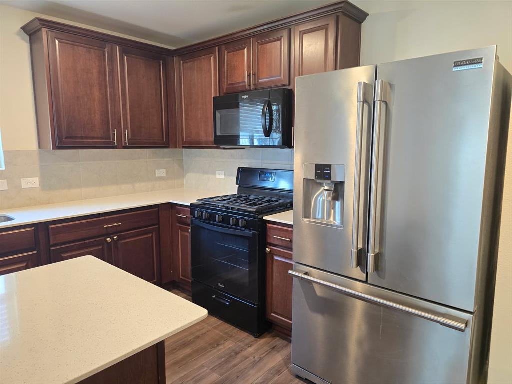 16029 Pemberly Lane Haslet, TX 76052 - Photo 4 of 19 a kitchen with stainless steel appliances granite countertop a refrigerator and a sink