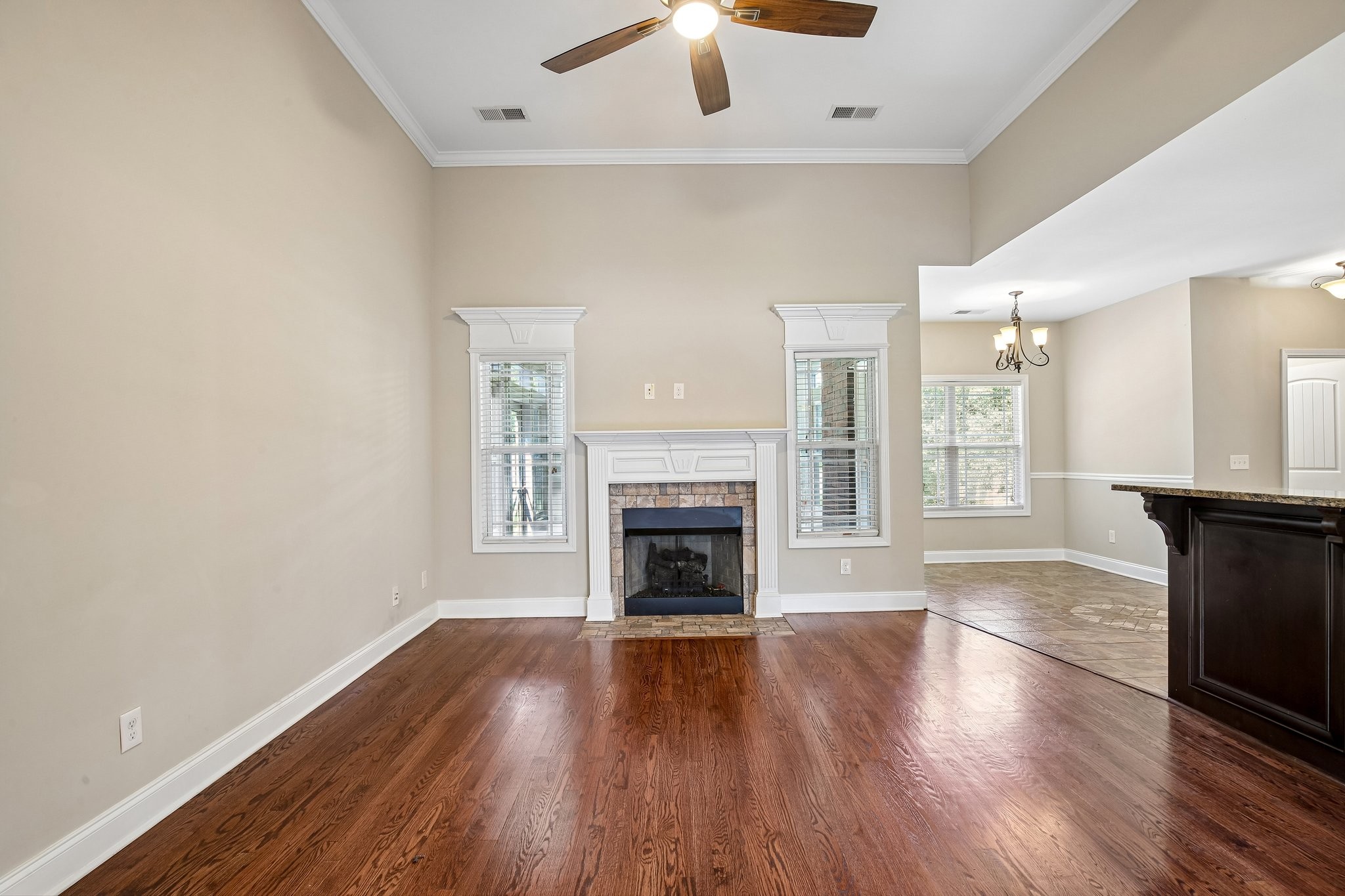 316 Amazonway Ridge Lascassas, TN 37085 - Photo 4 of 36 an empty room with wooden floor fireplace and windows
