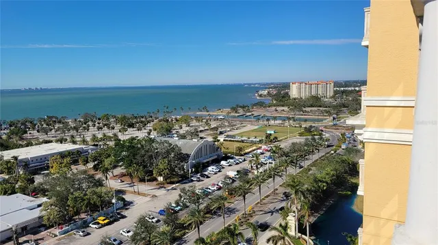 a large bed sitting in a bedroom next to a lamp