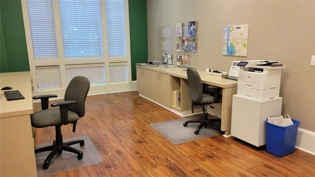 a living room with furniture a wooden floor and windows