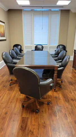 a dining room with furniture and a flat screen tv