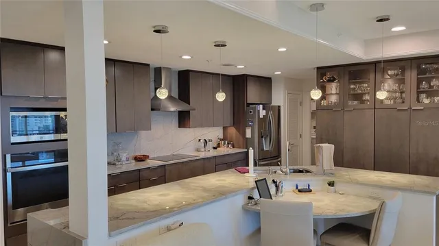 a kitchen with stainless steel appliances kitchen island granite countertop a sink and cabinets