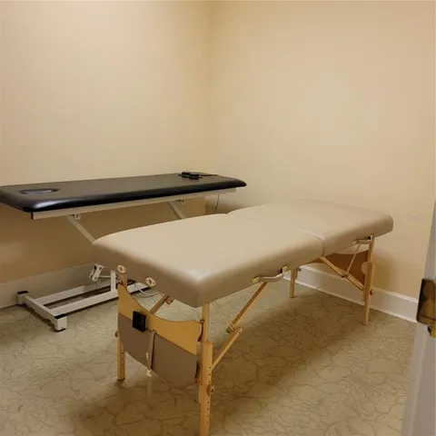 a view of swimming pool with outdoor seating and a forest