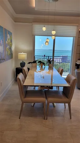 a view of a dining room with furniture and chandelier