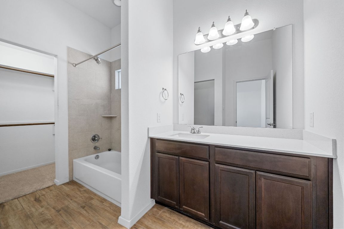 219 Trailside Lane Bastrop, TX 78602 - Photo 15 of 19 a bathroom with a tub a sink and mirror