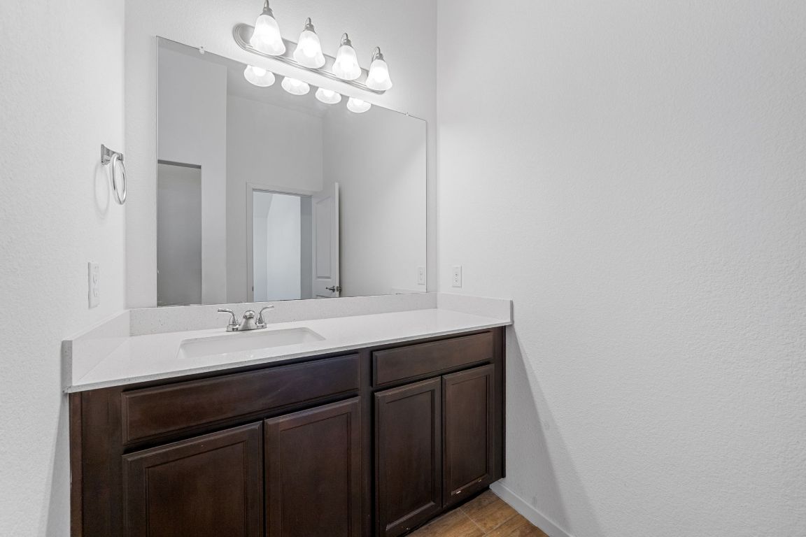 219 Trailside Lane Bastrop, TX 78602 - Photo 16 of 19 a bathroom with a sink and a mirror