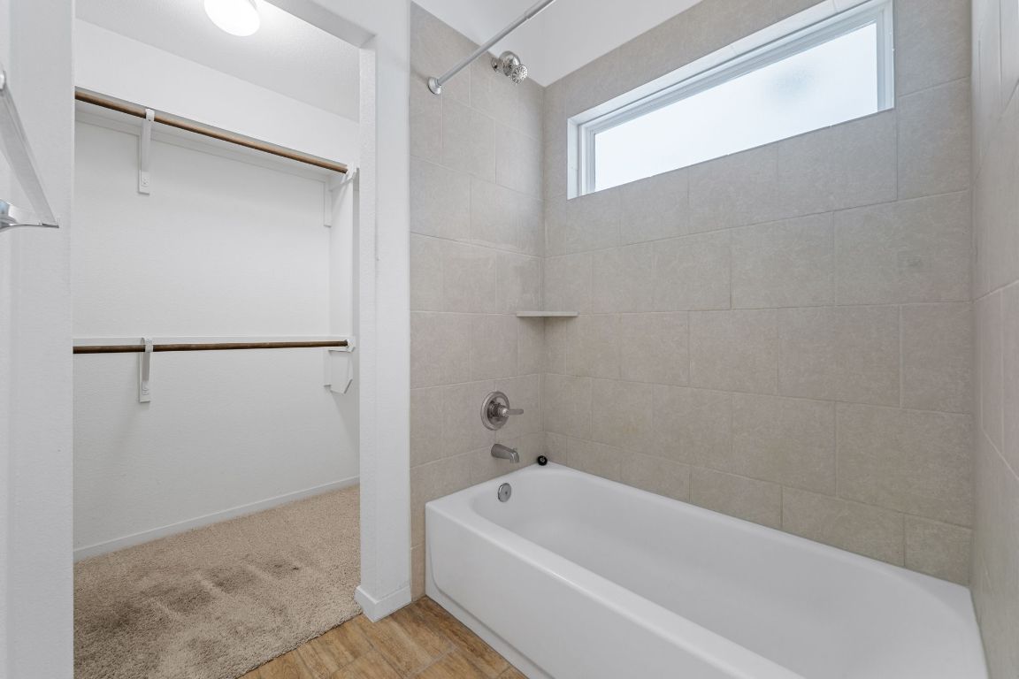 219 Trailside Lane Bastrop, TX 78602 - Photo 17 of 19 a bathroom with a bathtub and a shower