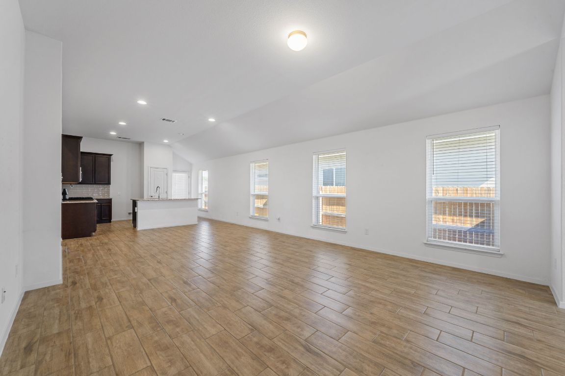 219 Trailside Lane Bastrop, TX 78602 - Photo 2 of 19 a view of empty room with wooden floor and windows