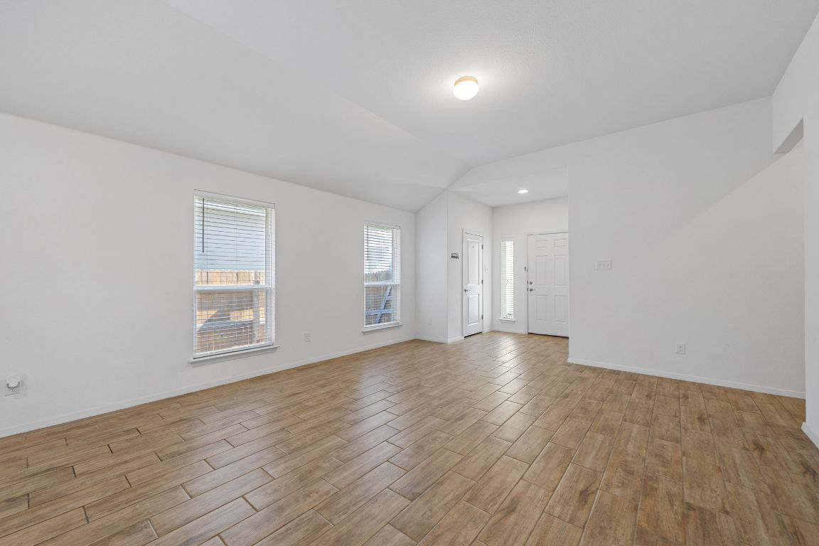 219 Trailside Lane Bastrop, TX 78602 - Photo 3 of 19 wooden floor in an empty room with a window
