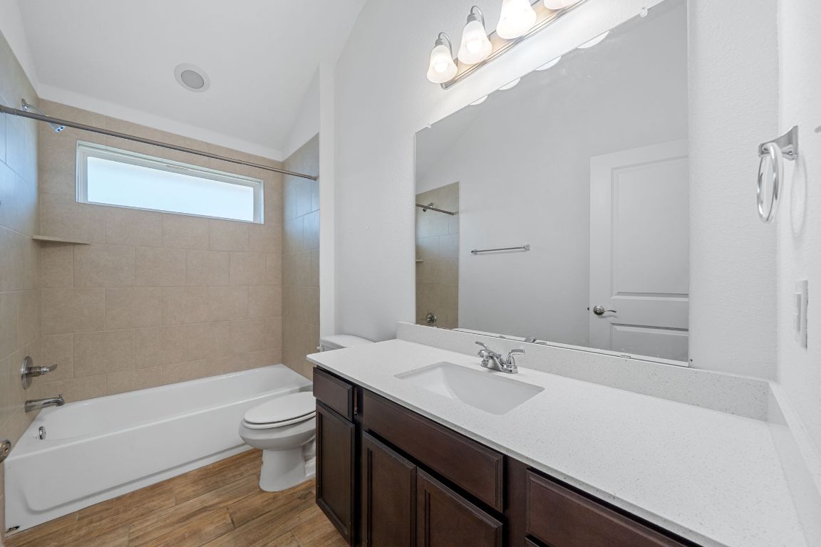 219 Trailside Lane Bastrop, TX 78602 - Photo 10 of 19 a bathroom with a sink a toilet and bathtub