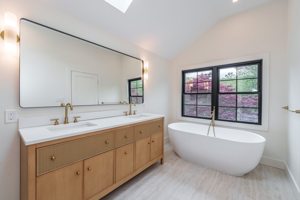 6 Hitching Post Lane Wilbraham, MA 01095 - Photo 23 of 34 a spacious bathroom with a bathtub double sink and mirror