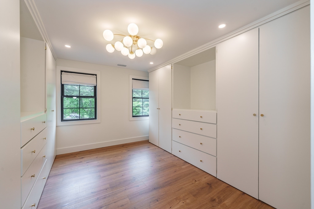 6 Hitching Post Lane Wilbraham, MA 01095 - Photo 24 of 34 wooden floor with chandelier and window in an empty room
