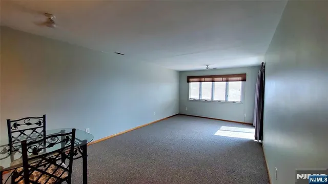 a view of a balcony with a chair and wooden floor