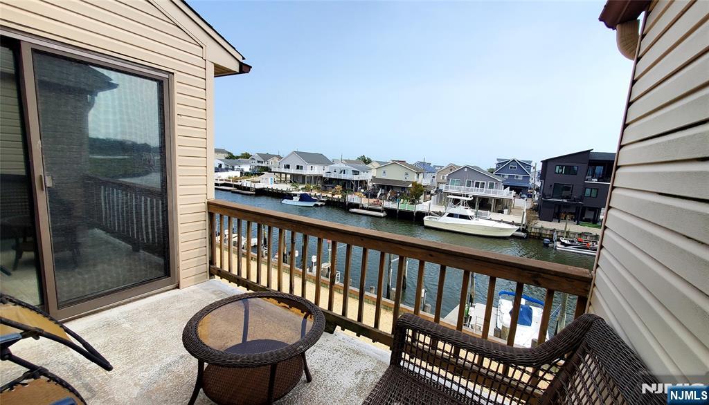 1159 Radio Road, Unit 7 Little Egg Harbor, NJ 08087 - Photo 18 of 38 a view of a balcony with a chair and wooden floor