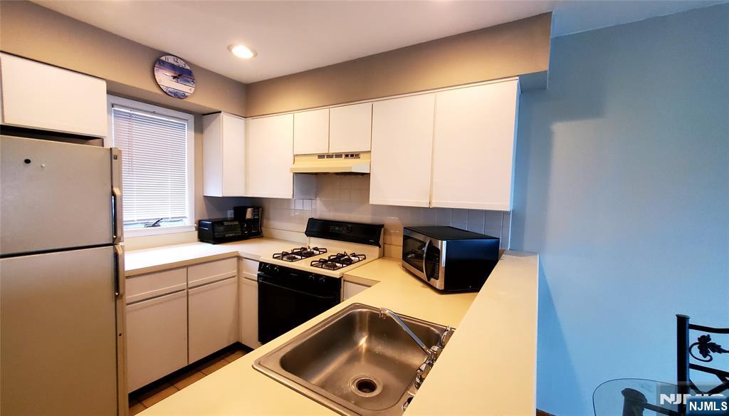 1159 Radio Road, Unit 7 Little Egg Harbor, NJ 08087 - Photo 8 of 38 a kitchen with a refrigerator sink and stove