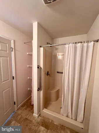 a bathroom with a shower and a sink