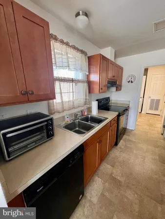 a kitchen with stainless steel appliances a sink stove and cabinets