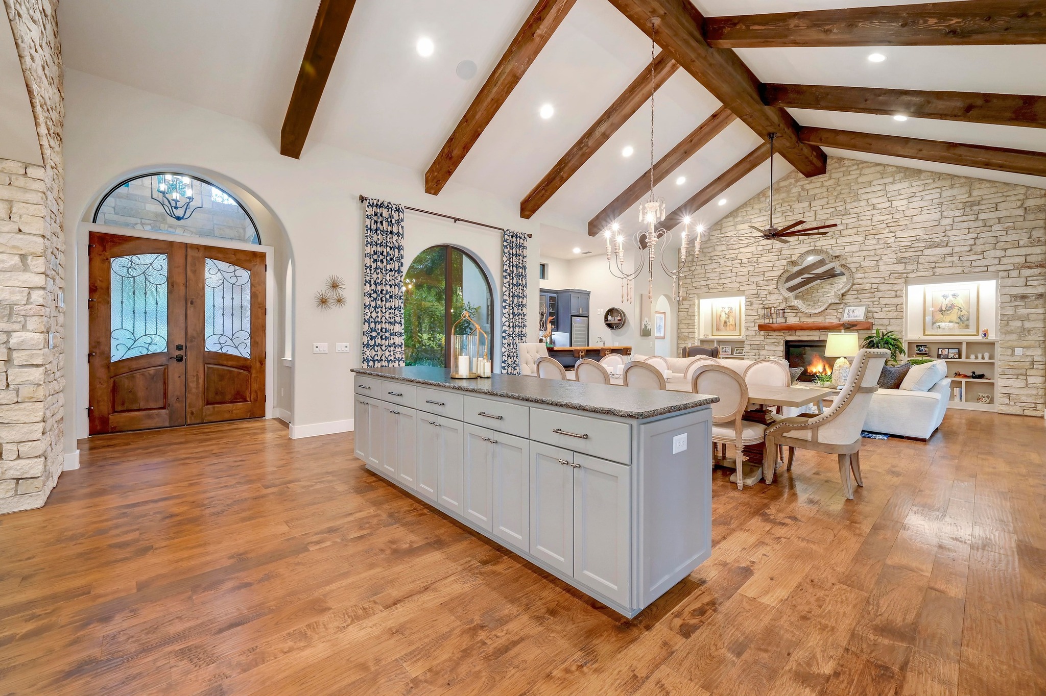 401 Trail Ridge Road Wimberley, TX 78676 - Photo 34 of 34 Kitchen featuring high vaulted ceiling, open floor plan, light wood finished floors, beamed ceiling, and a chandelier