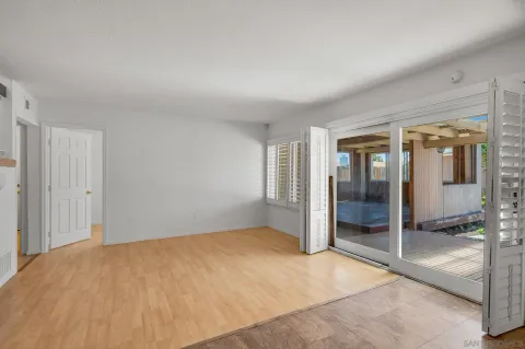 a view of a big room with wooden floor and windows