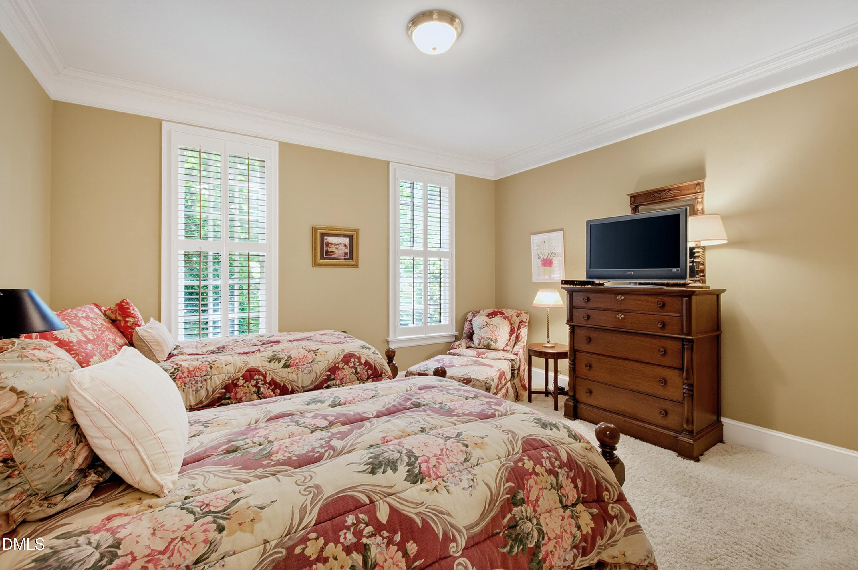 3708 Lubbock Drive Raleigh, NC 27612 - Photo 29 of 64 a bedroom with a bed and a television