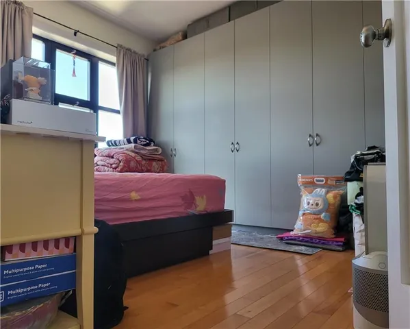 a bed room with a bed window and a table