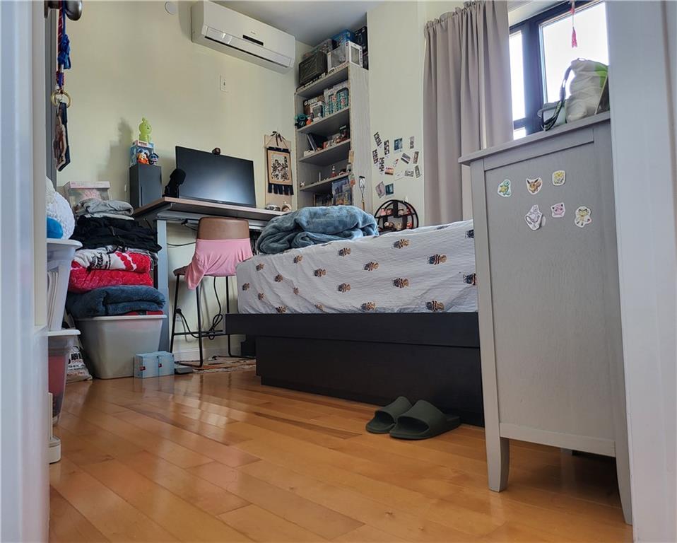 128 Bay 43rd Street, Unit 3D Brooklyn, NY 11214 - Photo 6 of 6 a bed room with a bed window and a table