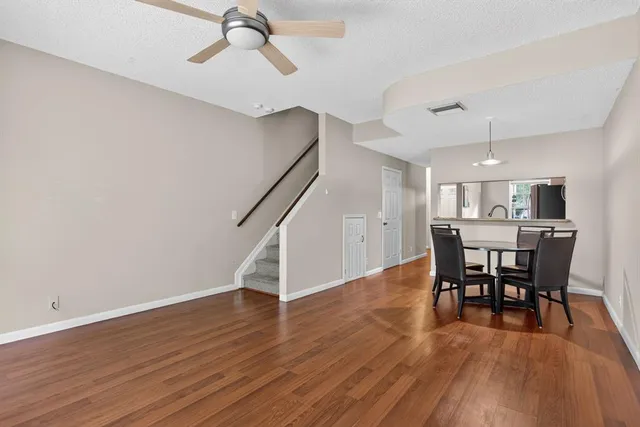 a view of a dining room with furniture and wooden floor