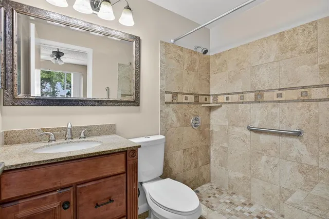 a bathroom with a sink a toilet and shower