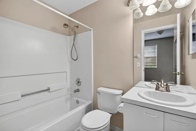 a bathroom with a sink toilet vanity and shower