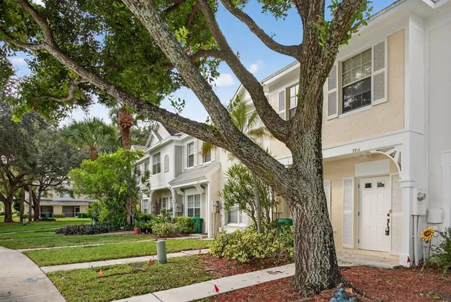 a front view of a house with a garden