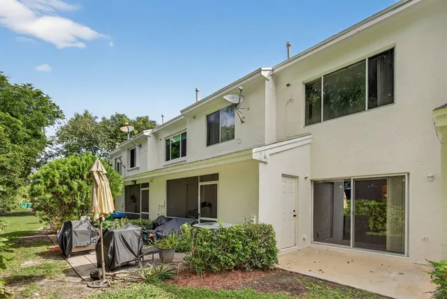 a front view of house with yard outdoor seating and barbeque oven