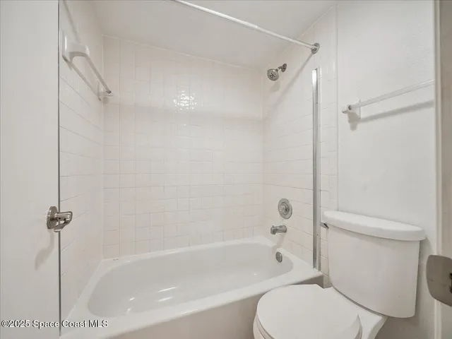 a bathroom with a toilet and a bath tub