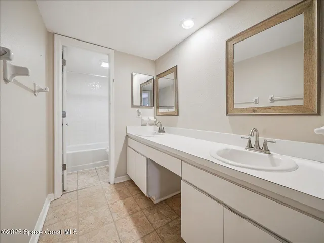 a bathroom with a double vanity sink mirror and
