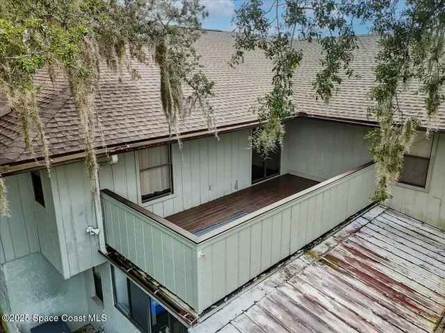 a view of balcony with wooden floor and fence