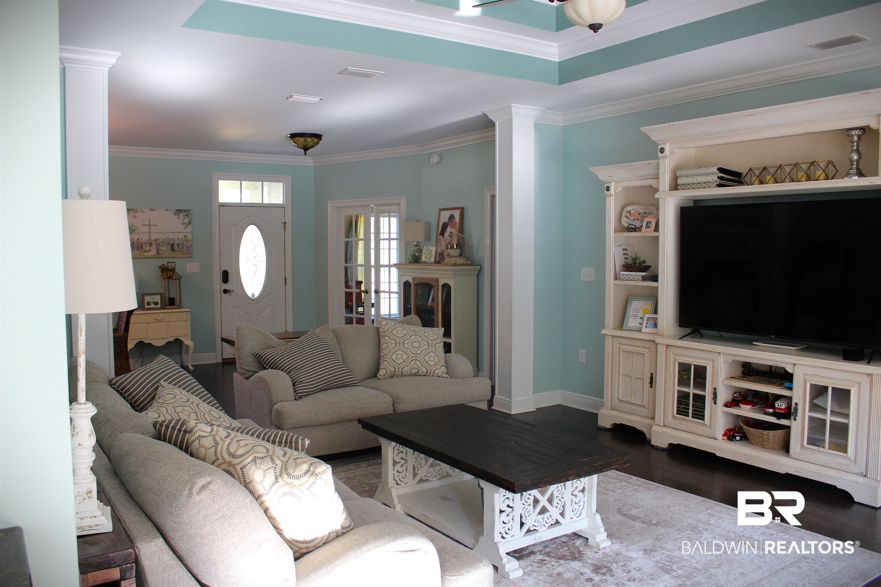 41416 Davis Duck Road Bay Minette, AL 36507 - Photo 16 of 72 Living room featuring decorative columns, dark hardwood / wood-style floors, and crown molding