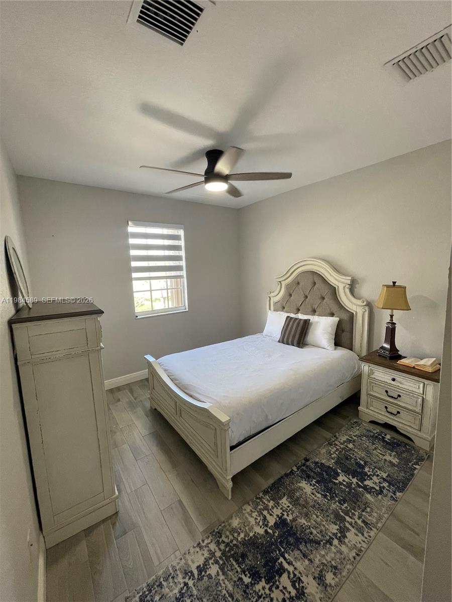 8900 Southwest 226th Terrace Cutler Bay, FL 33190 - Photo 12 of 40 a bedroom with a bed and window