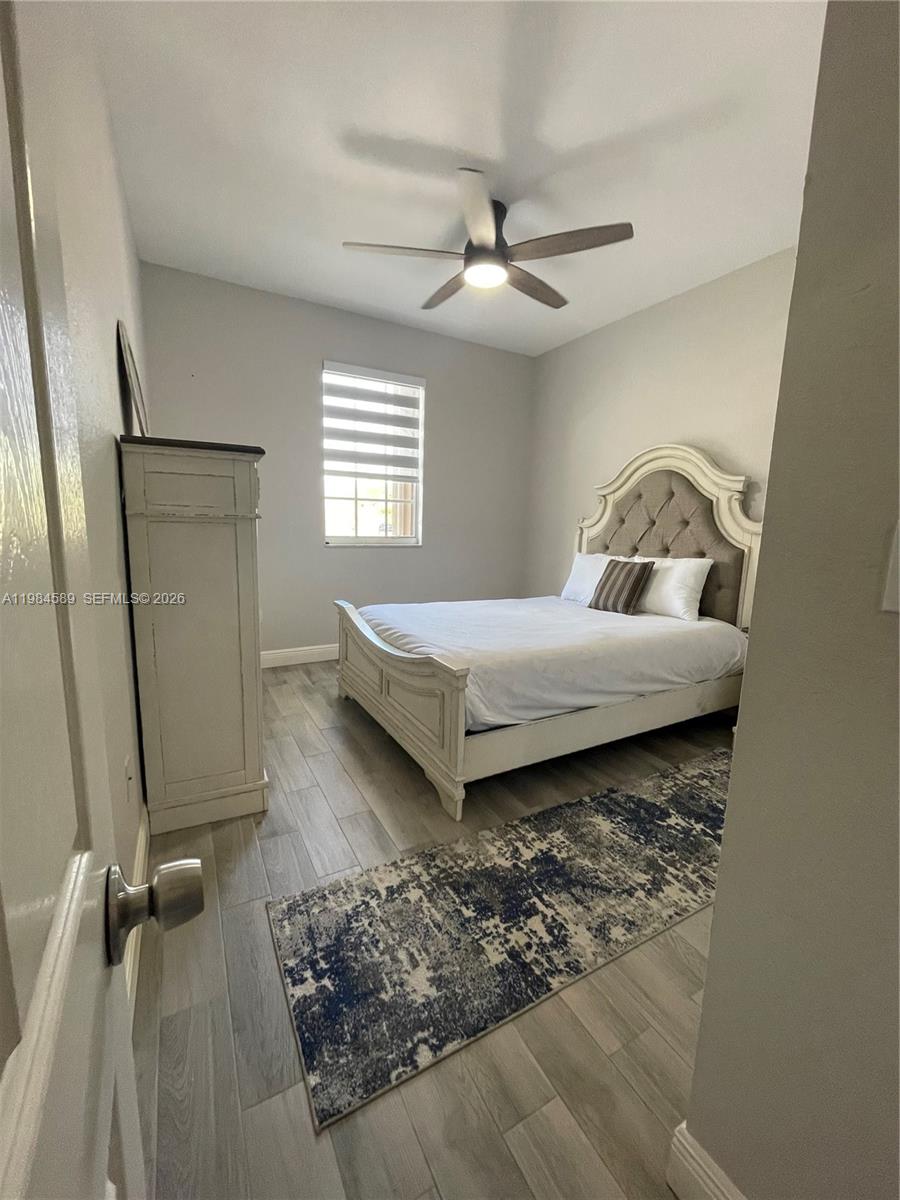 8900 Southwest 226th Terrace Cutler Bay, FL 33190 - Photo 13 of 40 a living room with a bed furniture and a window