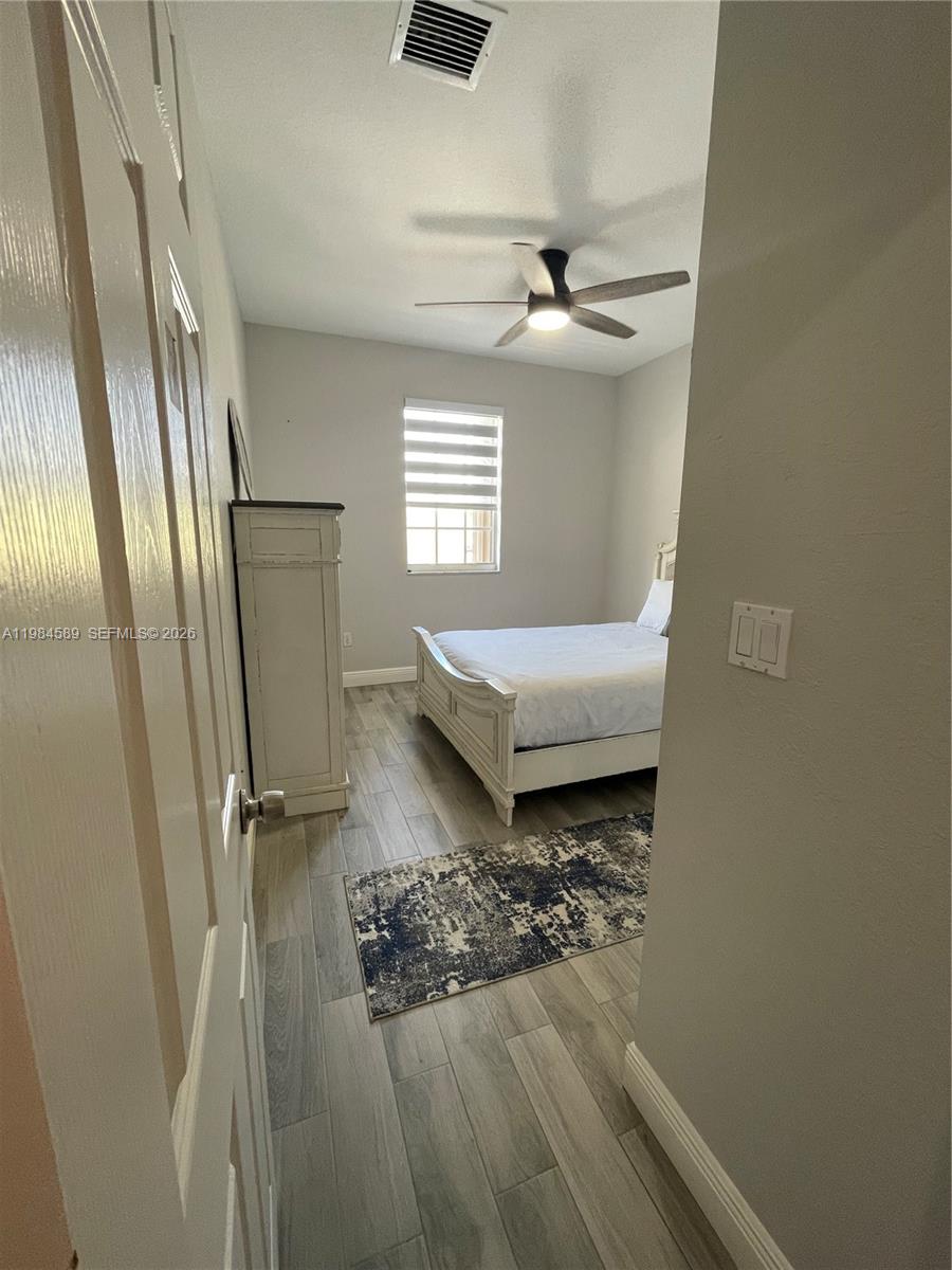 8900 Southwest 226th Terrace Cutler Bay, FL 33190 - Photo 15 of 40 a living room with couches and wooden floor