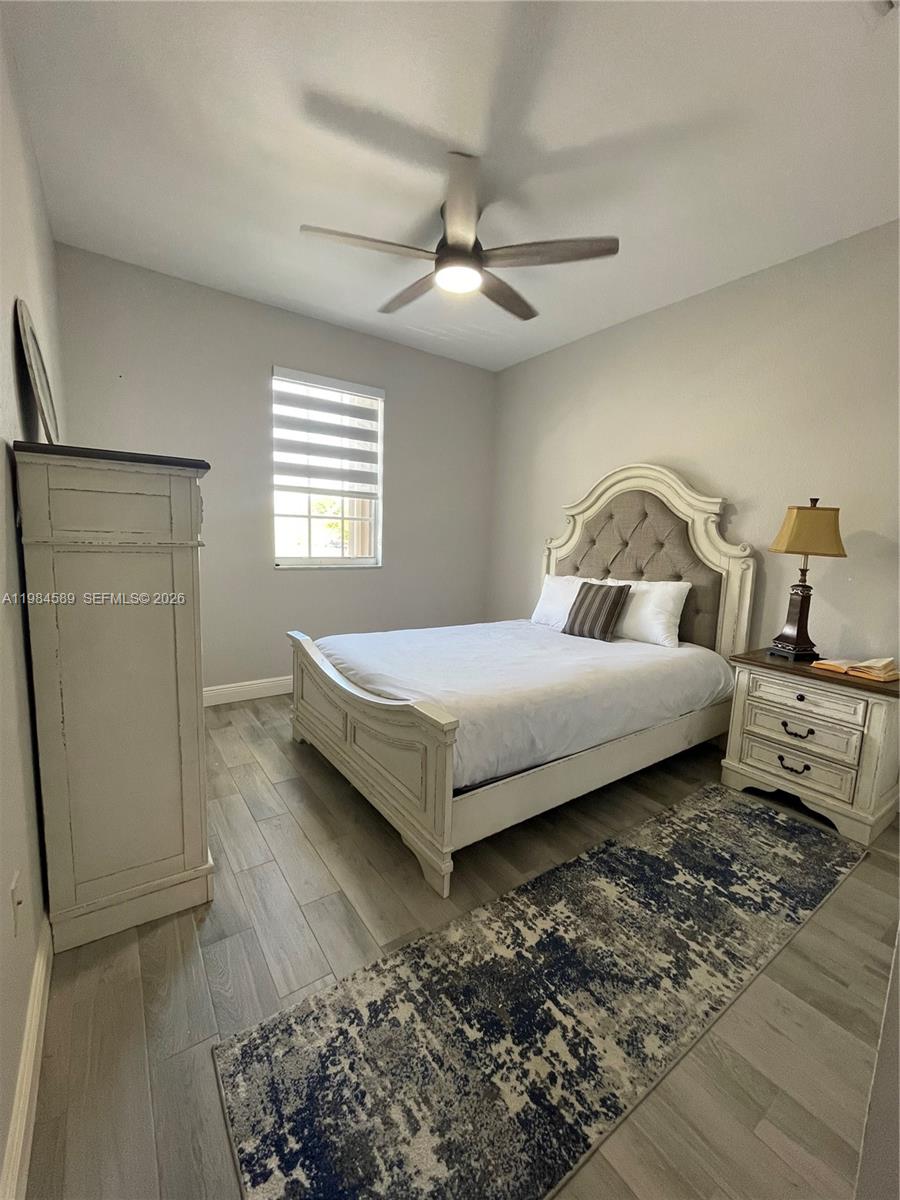 8900 Southwest 226th Terrace Cutler Bay, FL 33190 - Photo 16 of 40 a bedroom with a bed and a rug