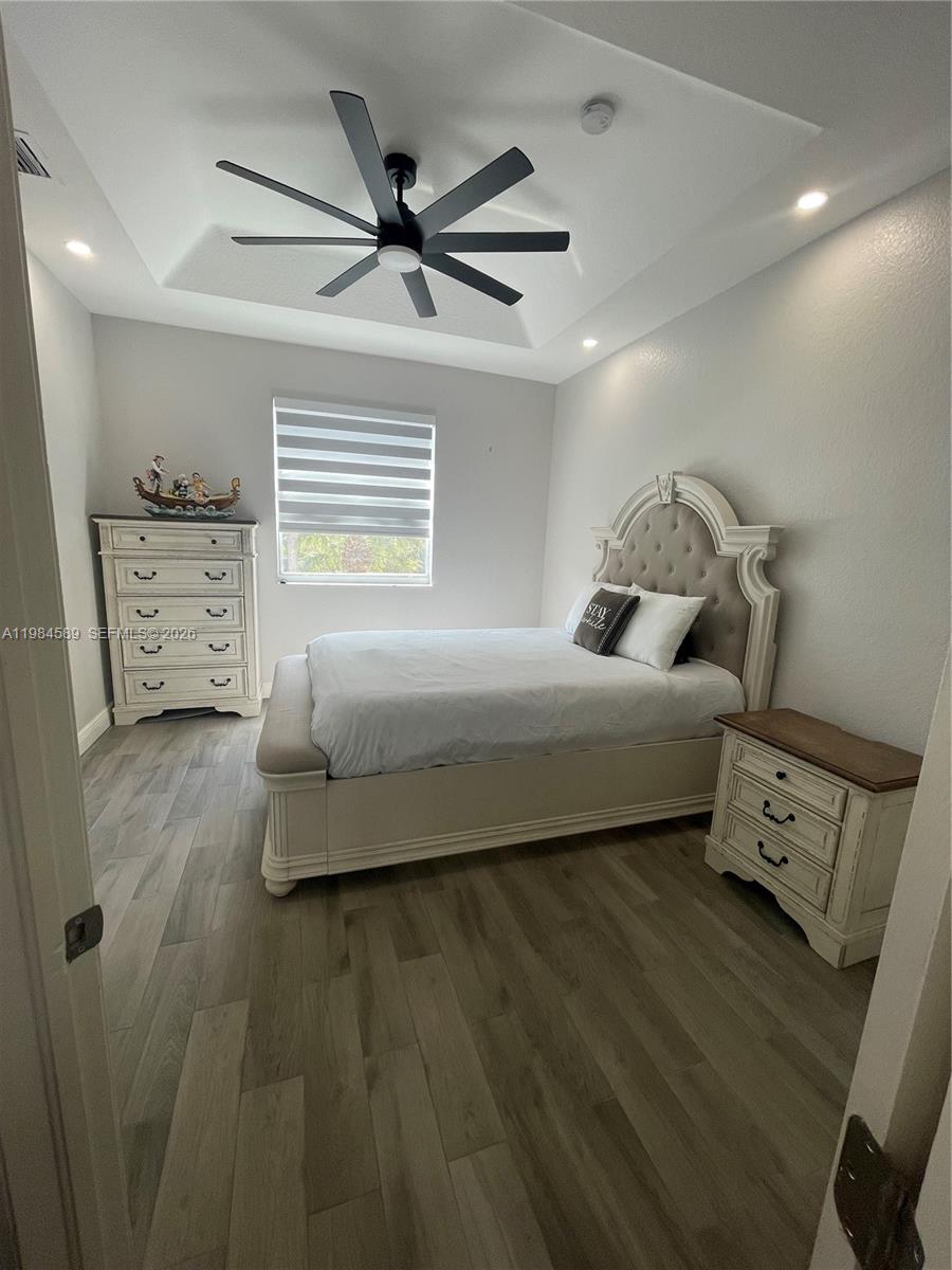 8900 Southwest 226th Terrace Cutler Bay, FL 33190 - Photo 22 of 40 a bedroom with a bed and a ceiling fan