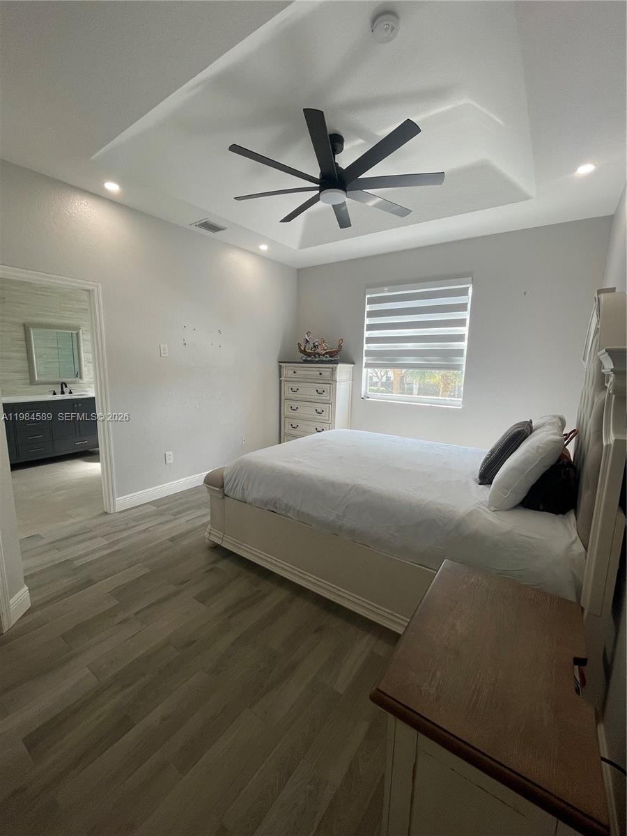 8900 Southwest 226th Terrace Cutler Bay, FL 33190 - Photo 23 of 40 a bedroom with a bed and a ceiling fan