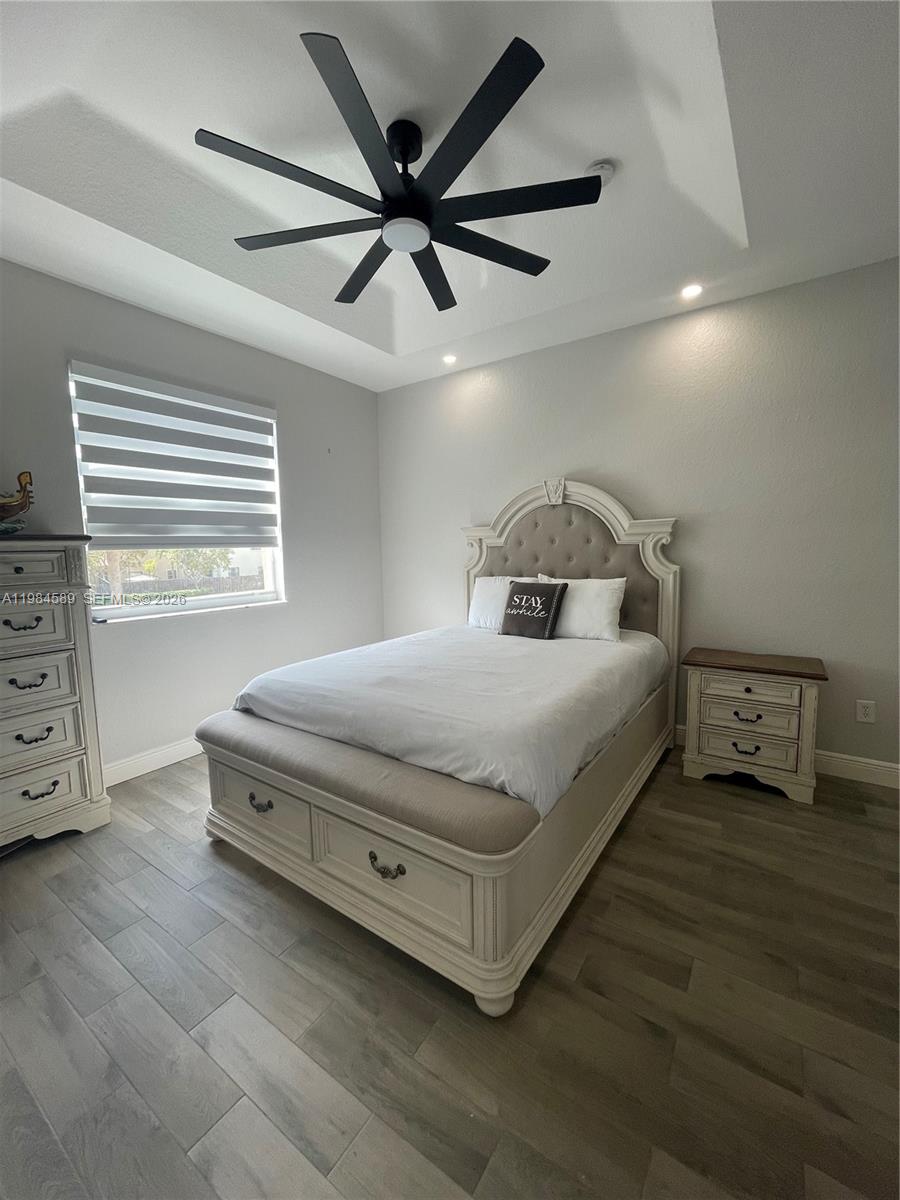 8900 Southwest 226th Terrace Cutler Bay, FL 33190 - Photo 24 of 40 a bedroom with a bed and a ceiling fan