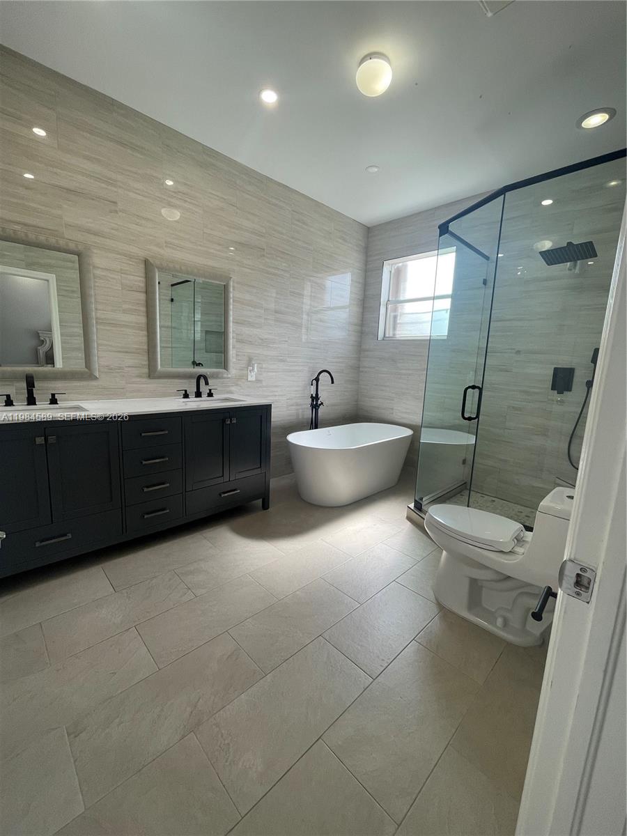 8900 Southwest 226th Terrace Cutler Bay, FL 33190 - Photo 26 of 40 a bathroom with a sink toilet and shower