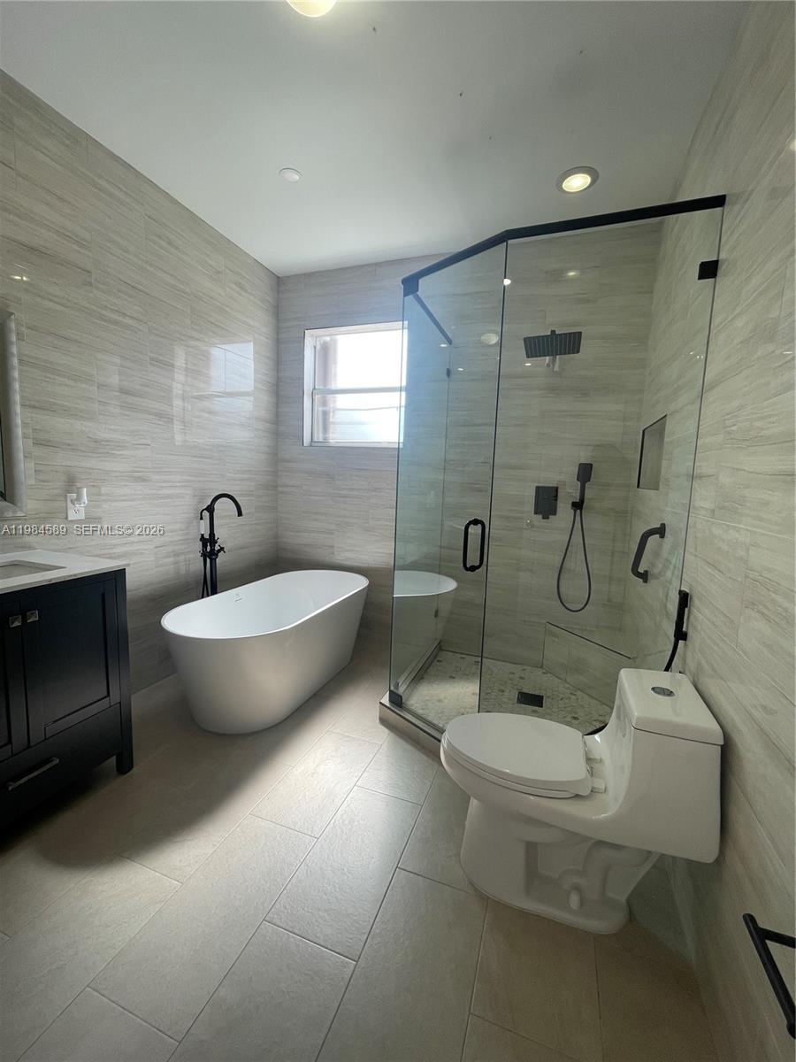 8900 Southwest 226th Terrace Cutler Bay, FL 33190 - Photo 27 of 40 a view of a bathroom with toilet windows and sink