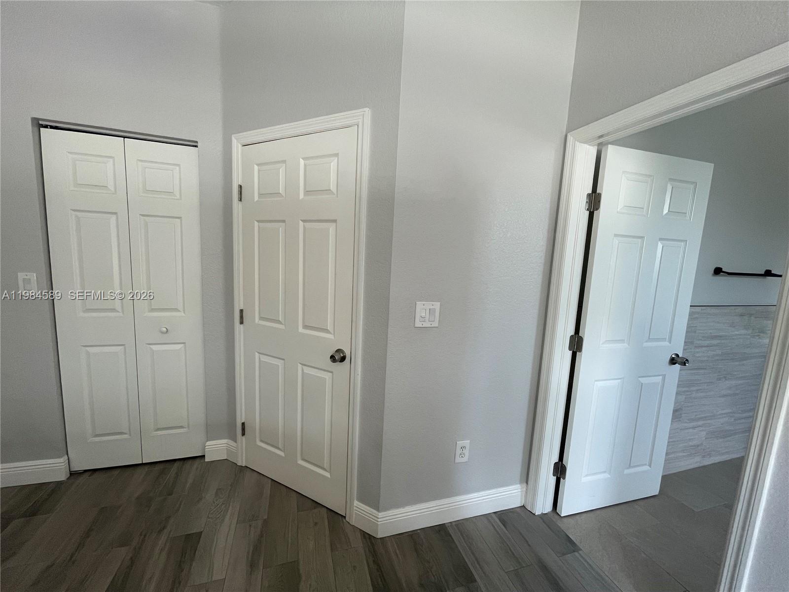 8900 Southwest 226th Terrace Cutler Bay, FL 33190 - Photo 29 of 40 an empty room with wooden floor and entrance
