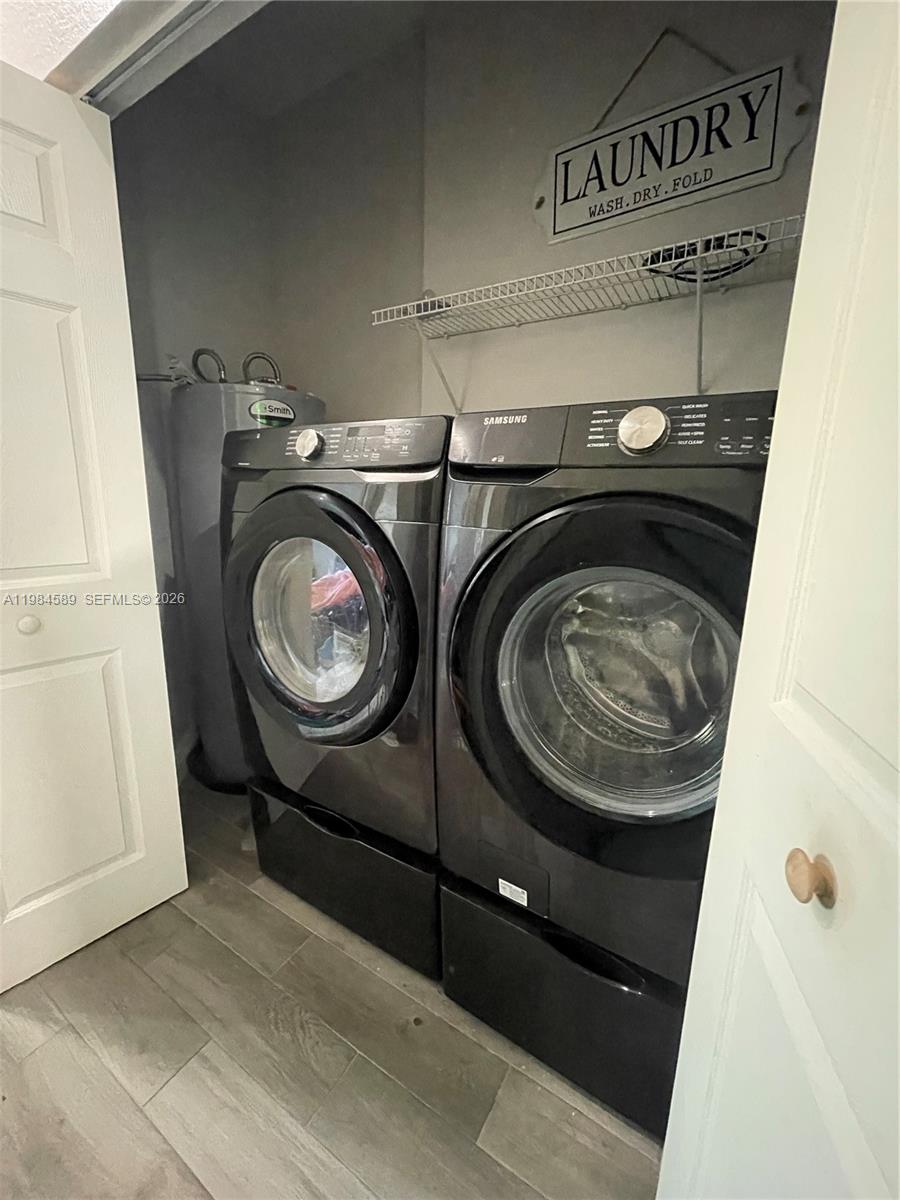 8900 Southwest 226th Terrace Cutler Bay, FL 33190 - Photo 32 of 40 a utility room with dryer and washer