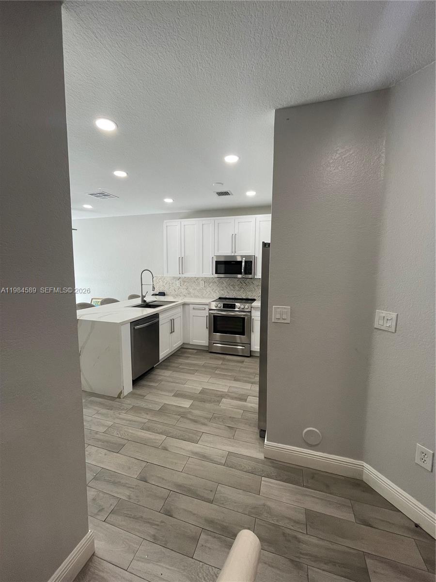 8900 Southwest 226th Terrace Cutler Bay, FL 33190 - Photo 34 of 40 a view of kitchen with wooden floor