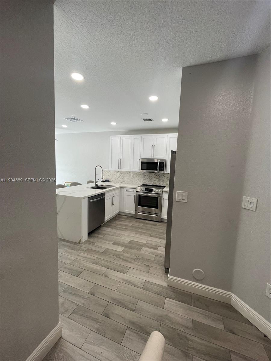 8900 Southwest 226th Terrace Cutler Bay, FL 33190 - Photo 8 of 40 a view of kitchen with wooden floor