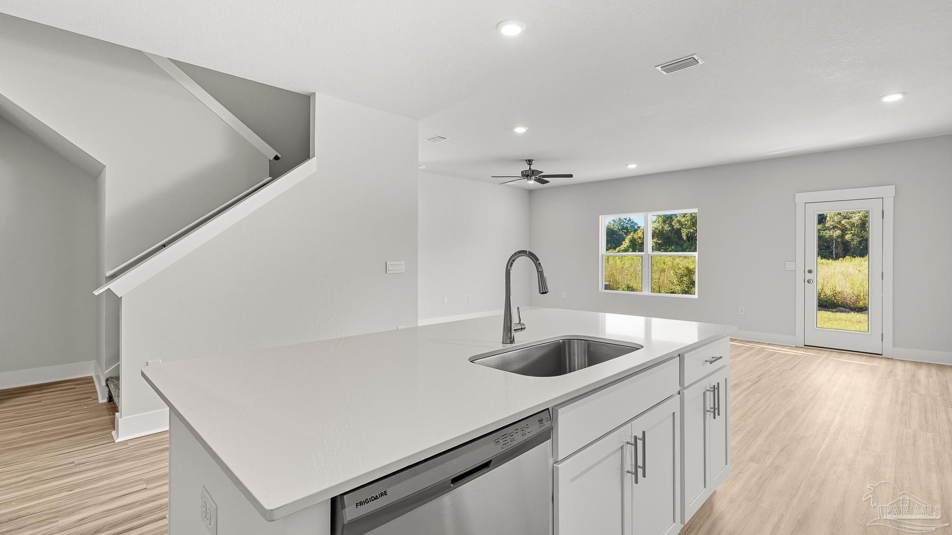 136 Albatross Street Cantonment, FL 32533 - Photo 12 of 43 a kitchen with a sink and a hard wood floor