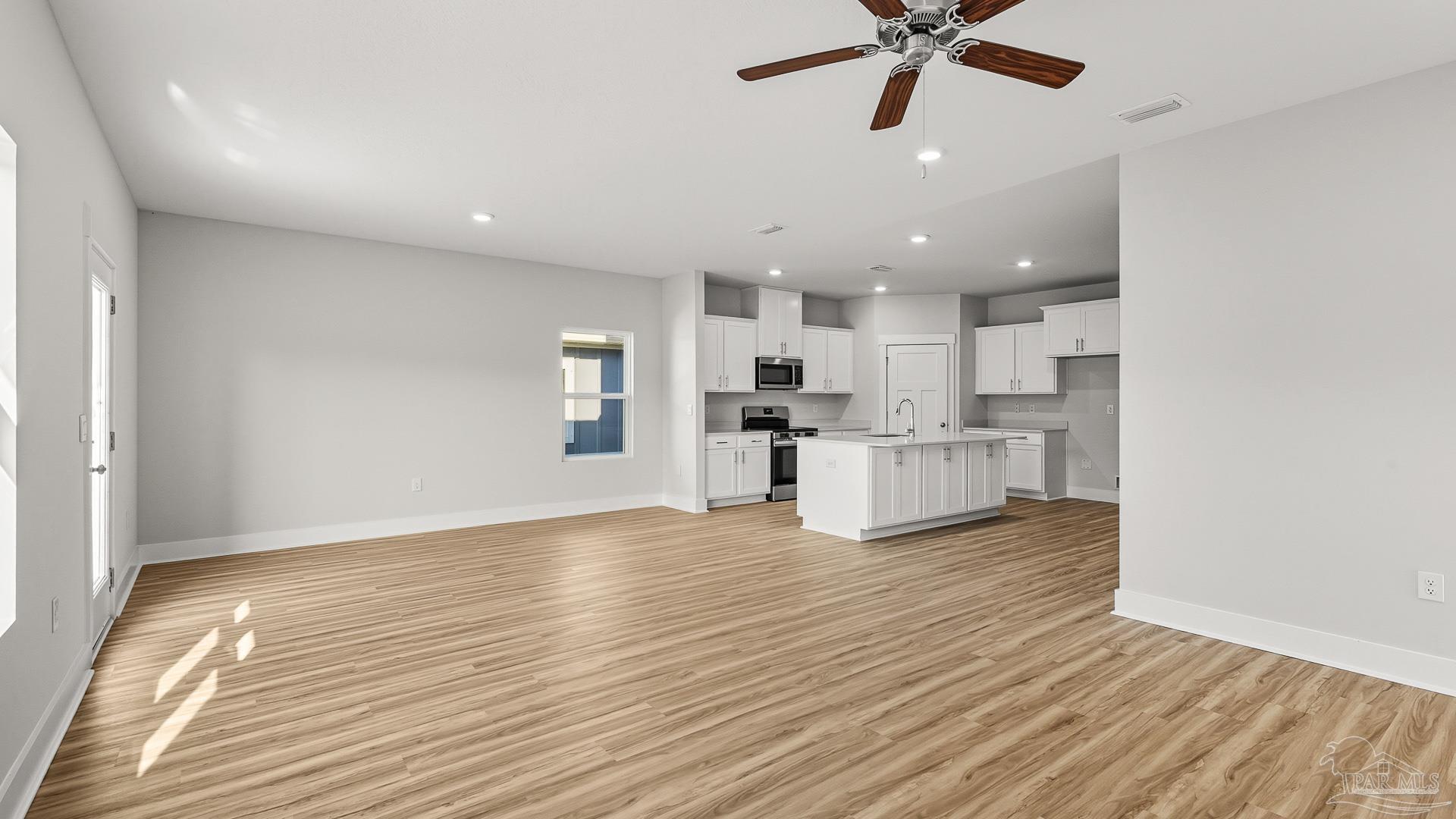 136 Albatross Street Cantonment, FL 32533 - Photo 14 of 43 a view of kitchen with wooden floor and window
